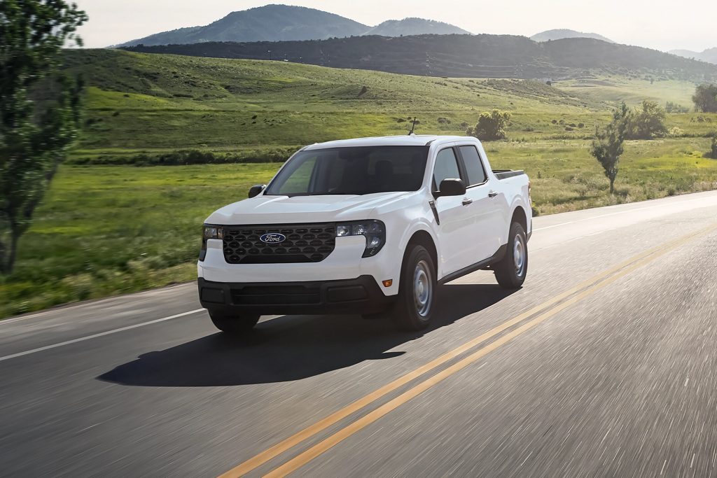 a white 2025 Ford Maverick drives down a road near Winchester, MA